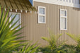 Maple Exterior Slat Wall Paneling With Black Accents and Embossed Wood-Effect Composite Siding